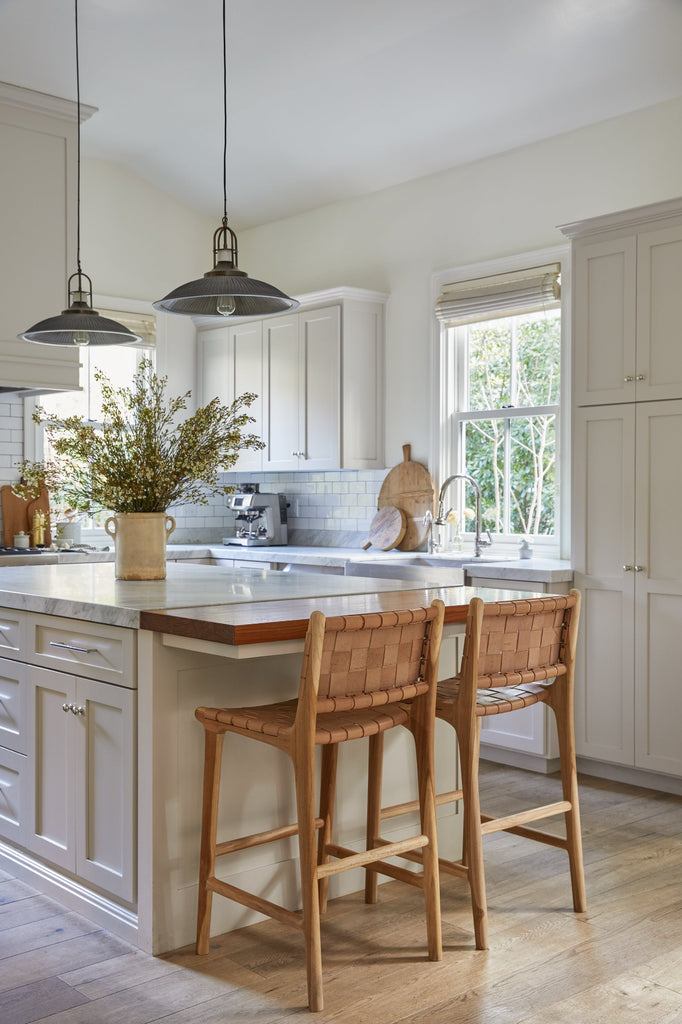 Woven Leather Counter Stool in Beige styled in a kitchen setting with Italian Confit Pot. - Saffron + Poe 