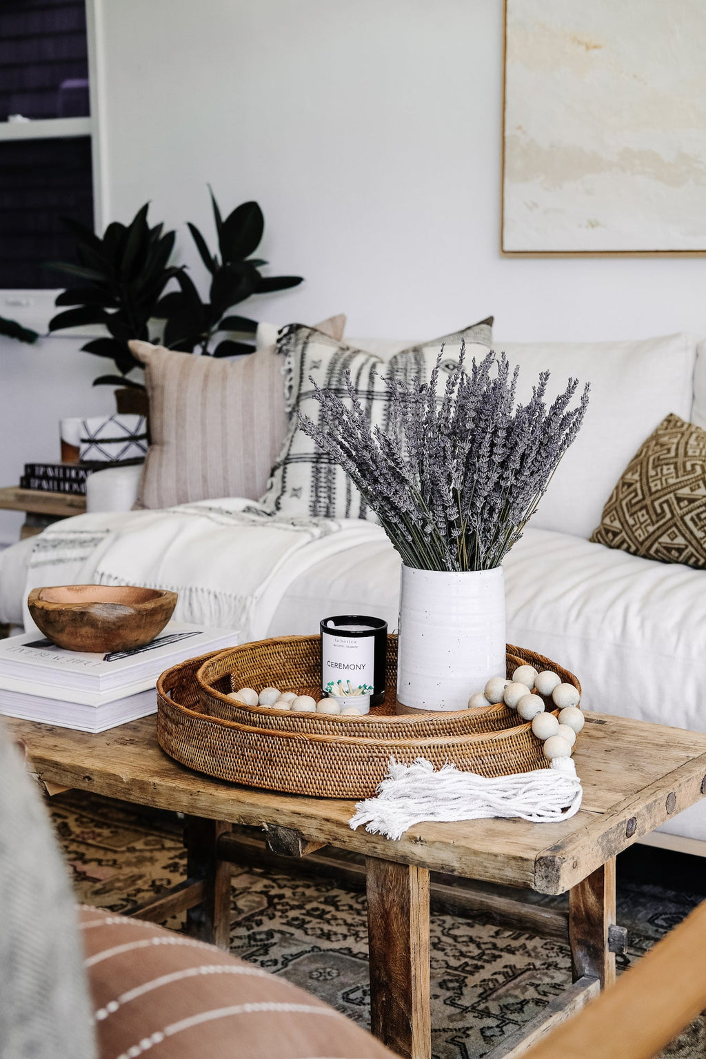 Round Tenganan Basket Trays on rustic wooden coffee table with decorative items in cozy living room