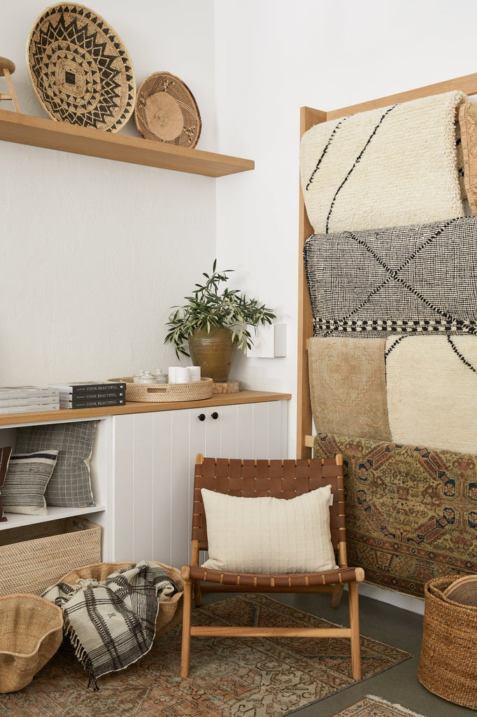 Styled shop view of our large Dancing Baskets with Handwoven Bhujodi Blanket, Turkish Runner and Woven Leather Strap Lounge Chair in Saddle. - Saffron and Poe