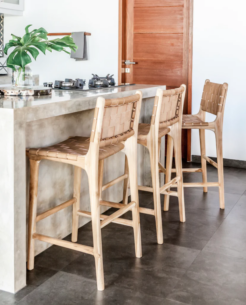 a set of leather woven counter stools