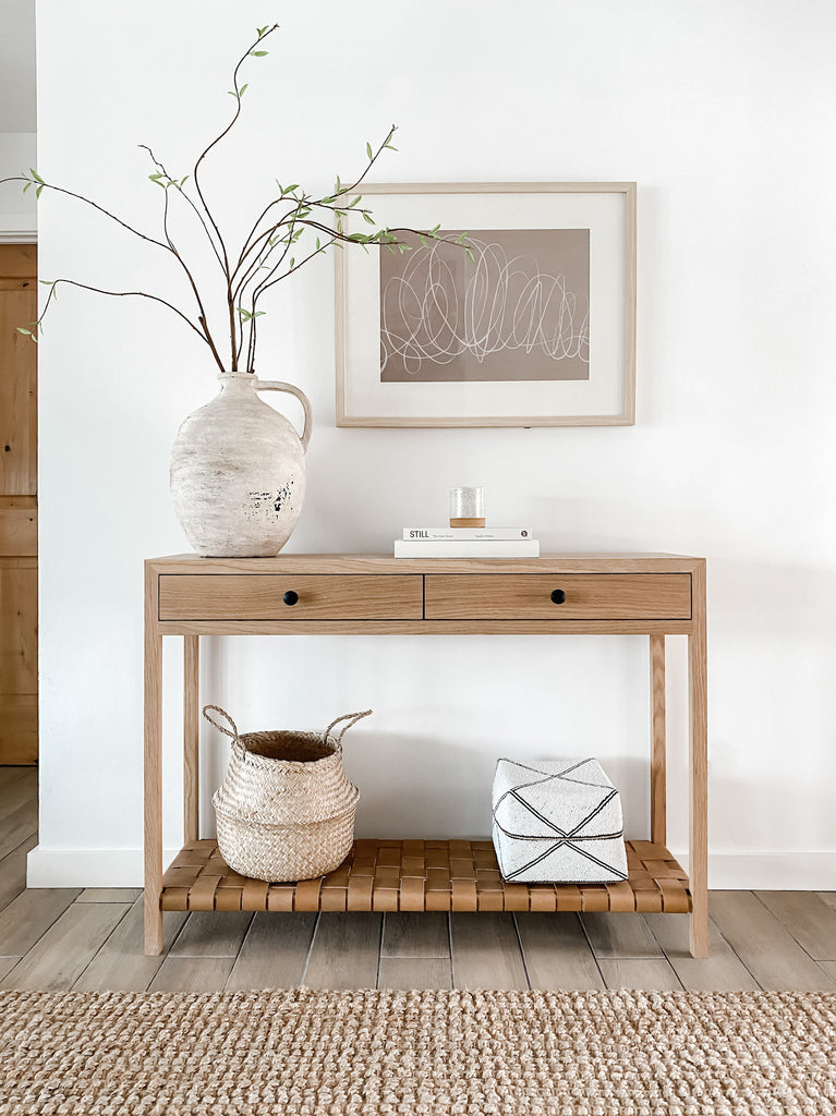 Styled view of White Oak Leather Strap Console with hand-beaded Bali basket. - Saffron and Poe