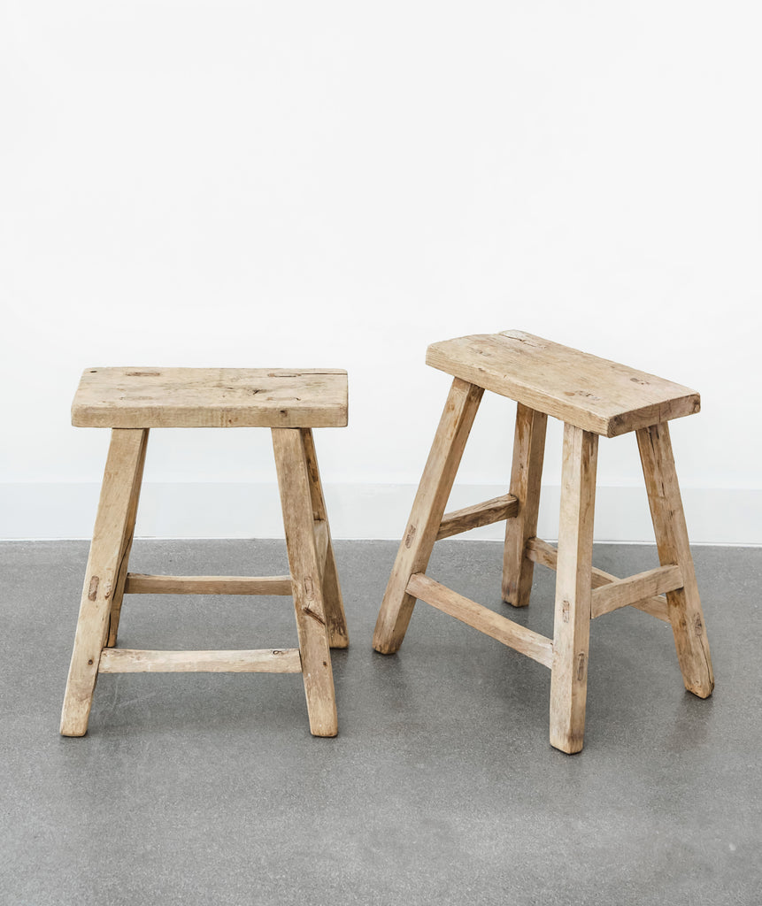 Two vintage rectangular stools in front and angled views on concrete floor with white walls. - Saffron and Poe