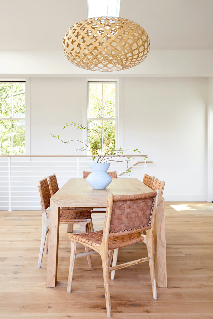 woven dining chairs with a wood table